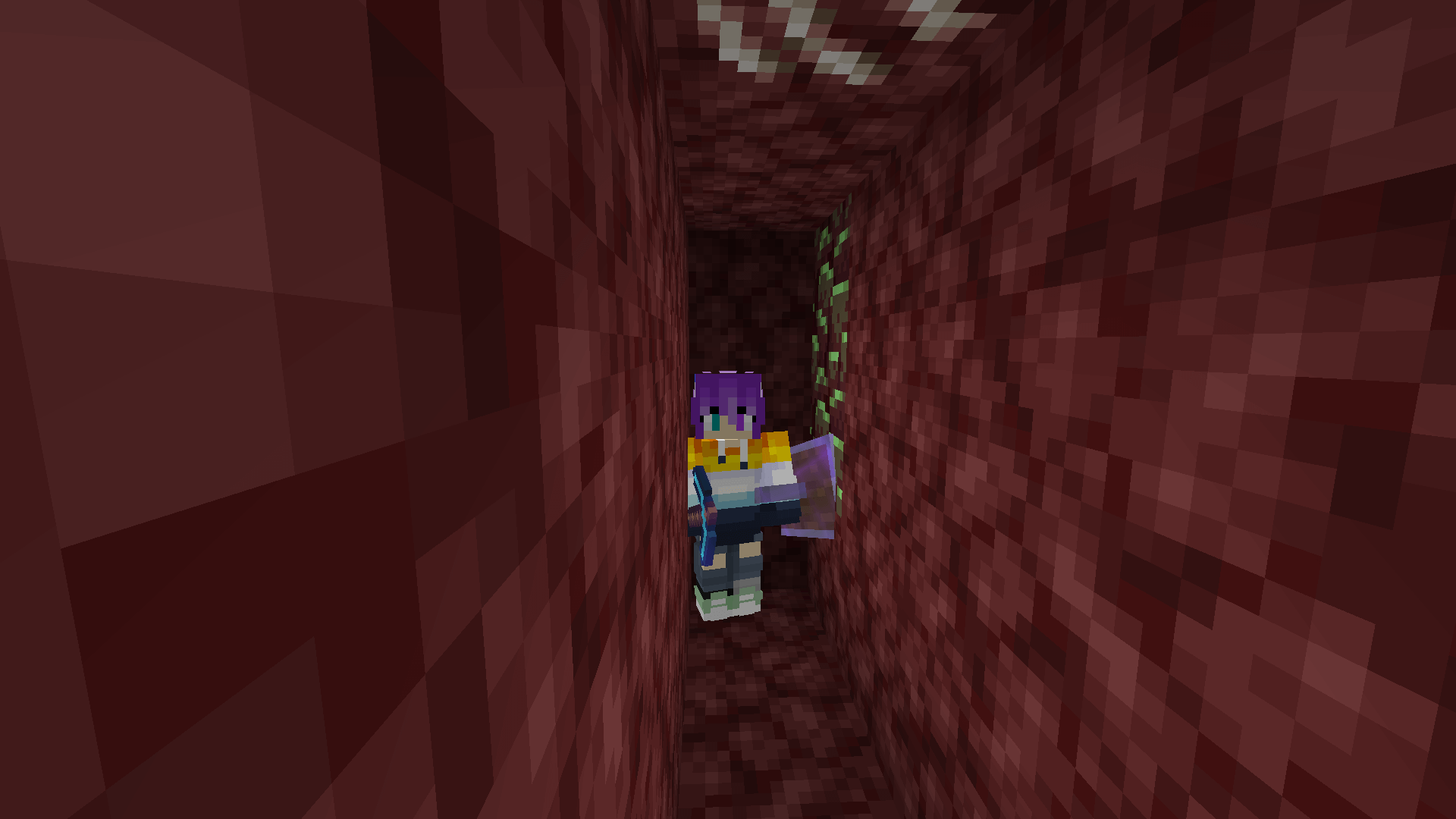 I sure hope this isn't radioactive. A Minecraft player stands in a small netherrack tunnel, with two blocks of ancient debris – coloured green – in the wall.