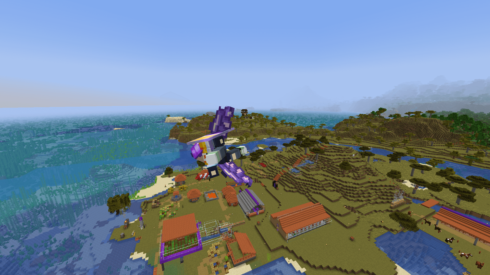 Taking a victory lap 🏆 A Minecraft player flying over a village, with mountains and a pillager tower in the background.