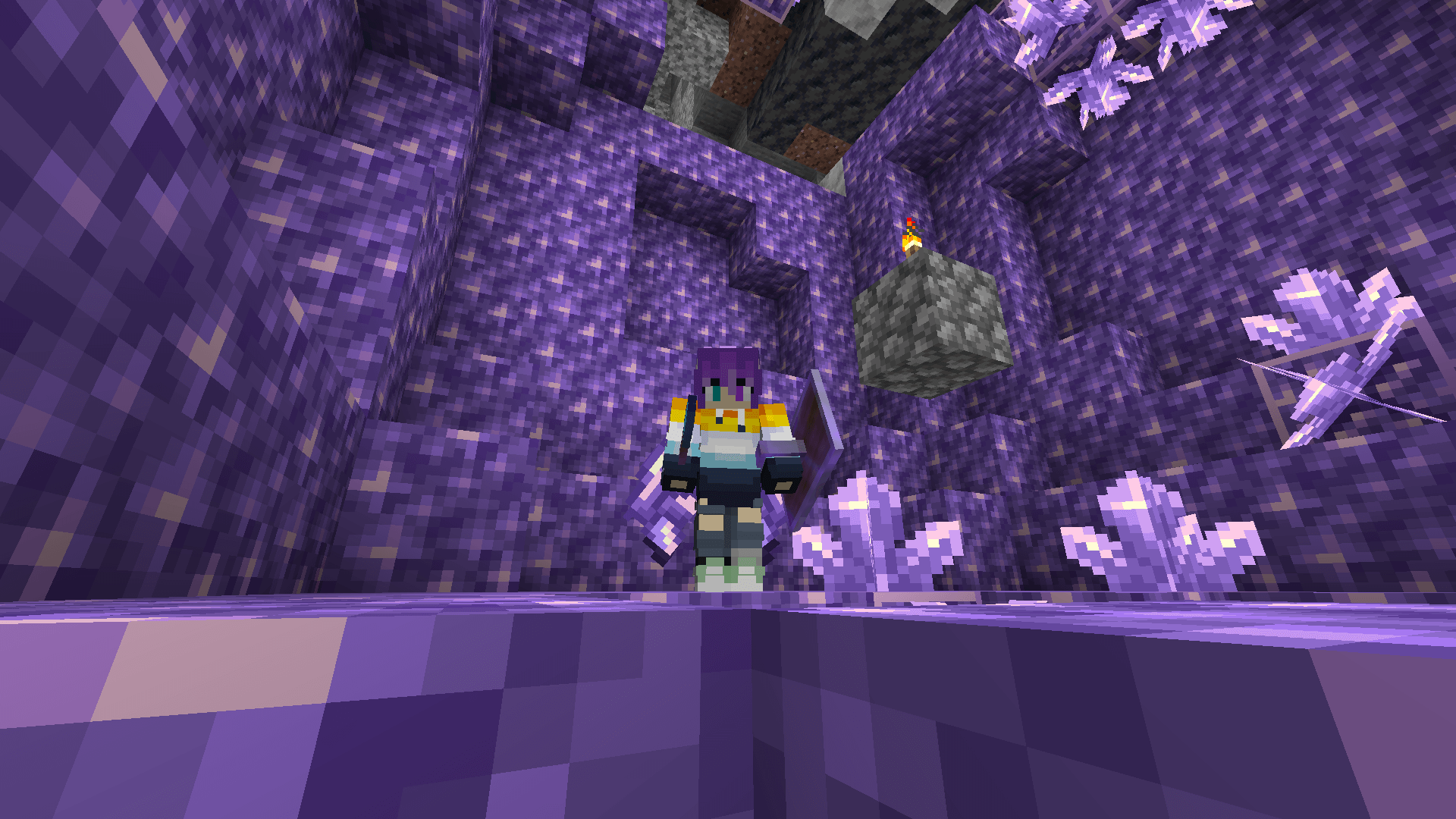 I'm in my crystal comfort zone! 💜 A Minecraft player stands in an amethyst geode. A cobblestone block with a torch sits suspended at the centre of the structure.