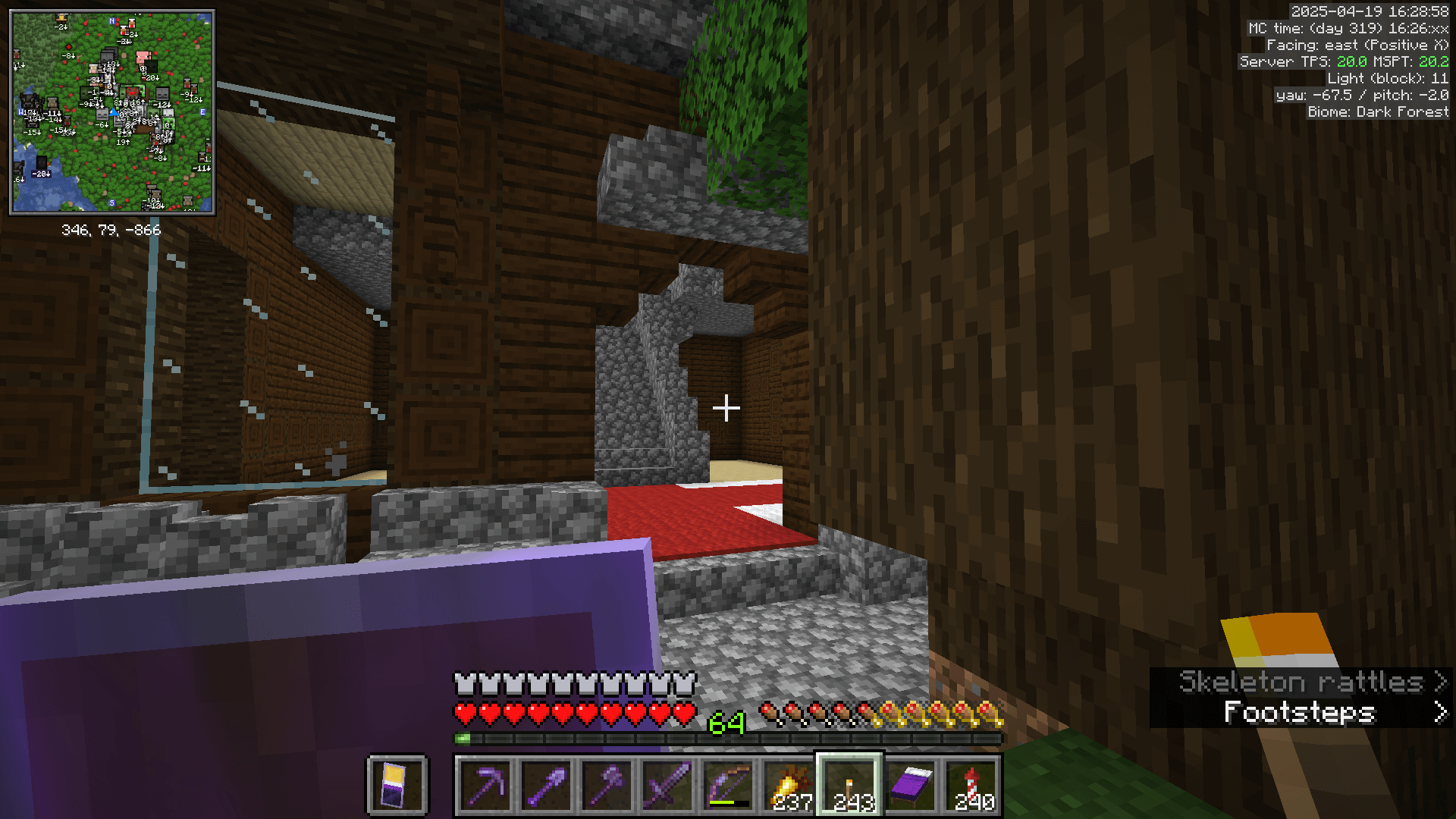 The front entrance of the woodland mansion, partly obscured by a dark oak tree.