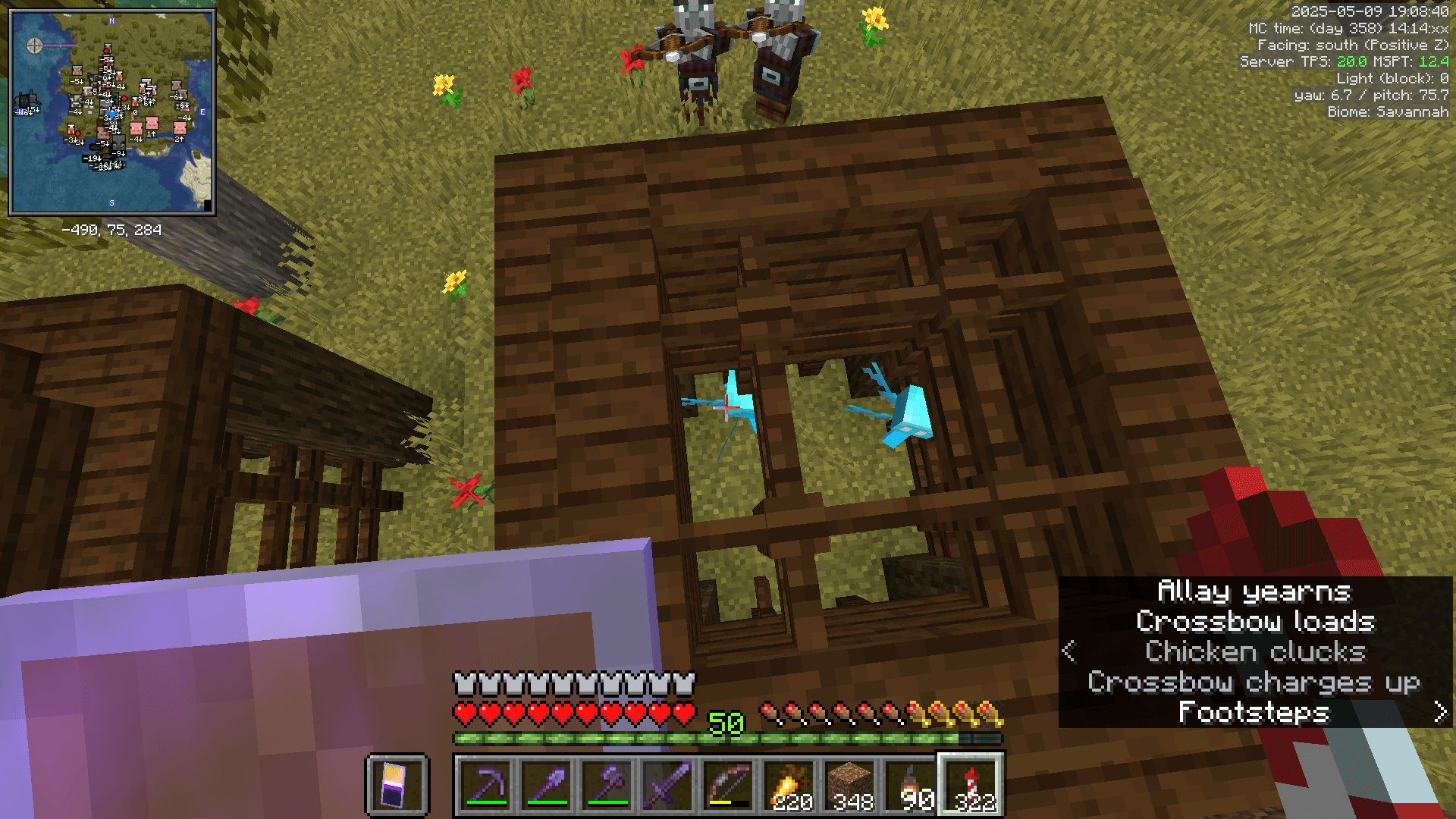 Standing on top of a pillager outpost prison cell, looking down at the two allays inside. At the top of view, two pillagers point their crossbows at the player.