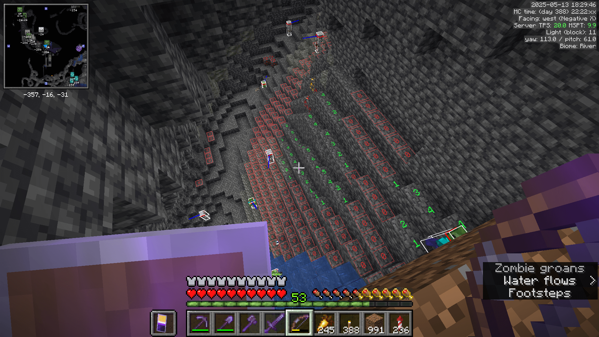 Looking down from a dirt bridge into a cave with a high density of mobs.