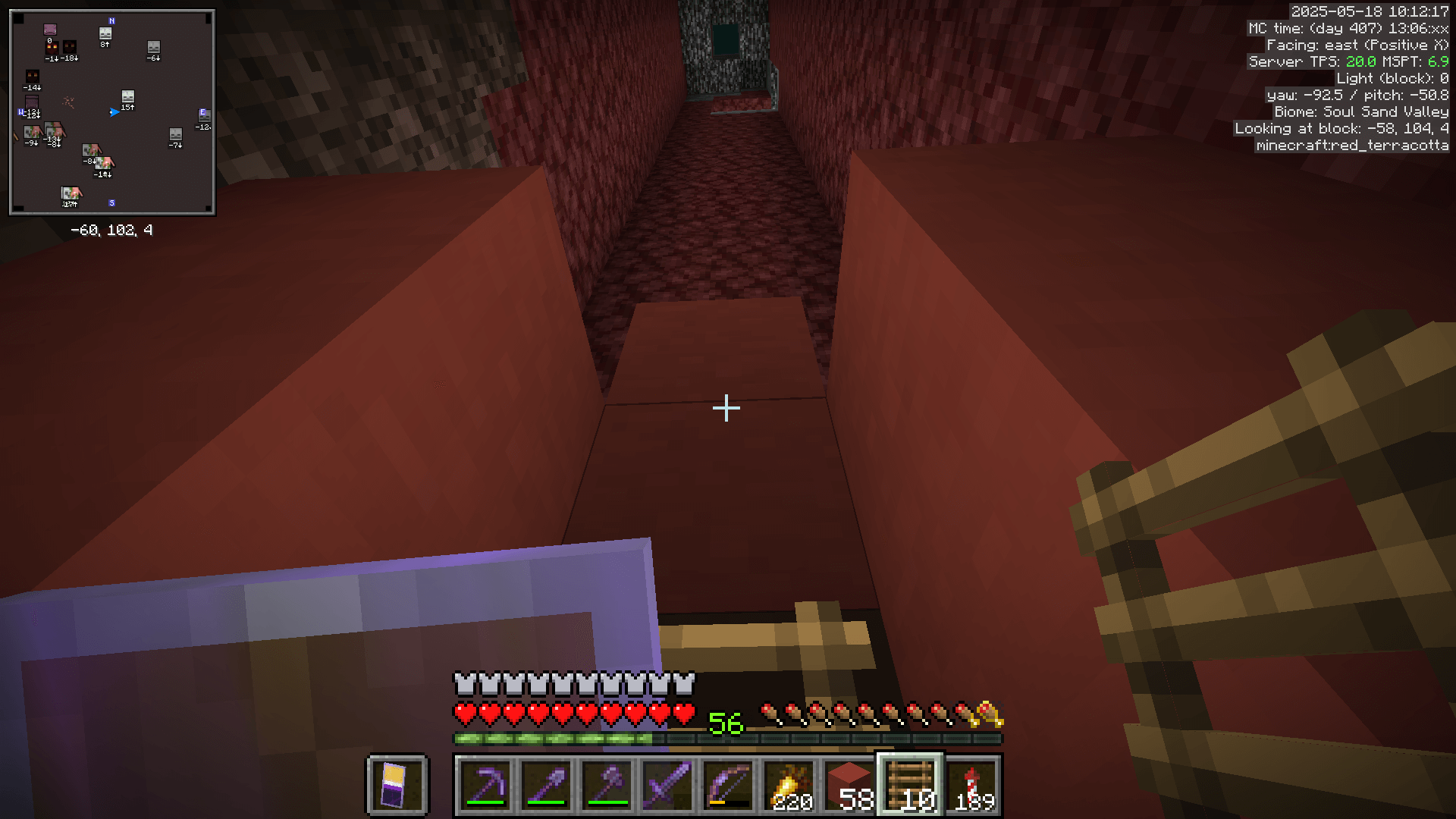 Continuing the coloured terracotta pillar, replacing the existing netherrack and soul sand, up to the bedrock ceiling of the nether.