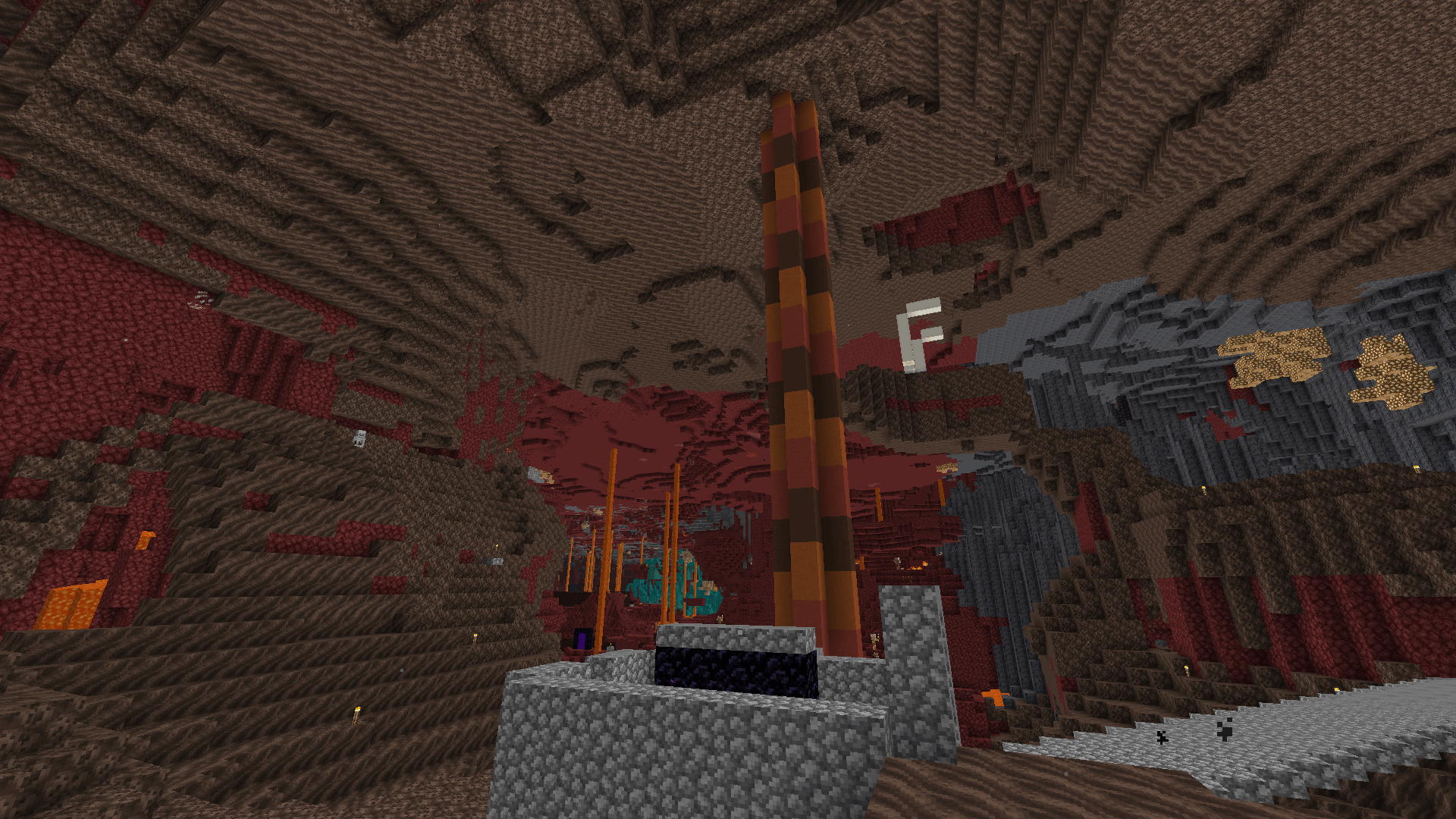 A column of red, orange and brown terracotta blocks rises to the ceiling of the nether.