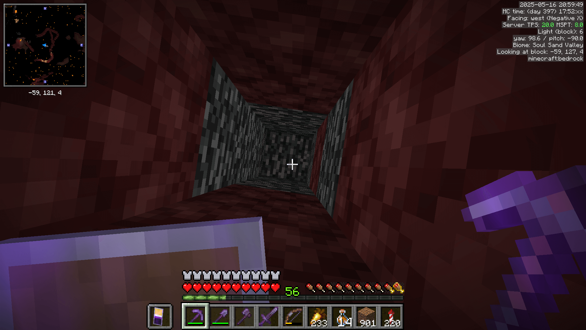 Looking up at a block of bedrock in the ceiling of the nether. This block has a y-coordinate of 127, as indicated by the Looking At Block value provided by MiniHUD.