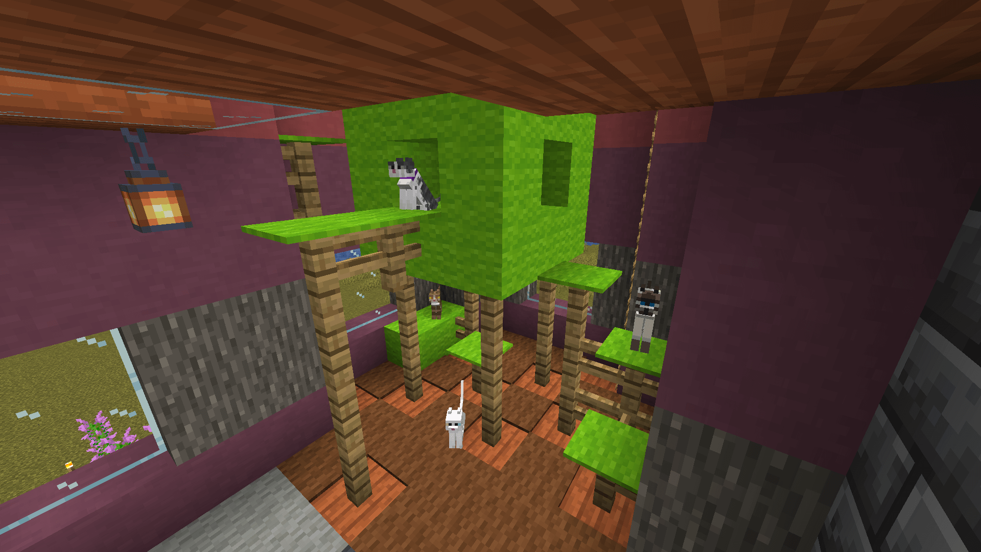 A cat tree made from oak fences and green wool, occupied by several cats.