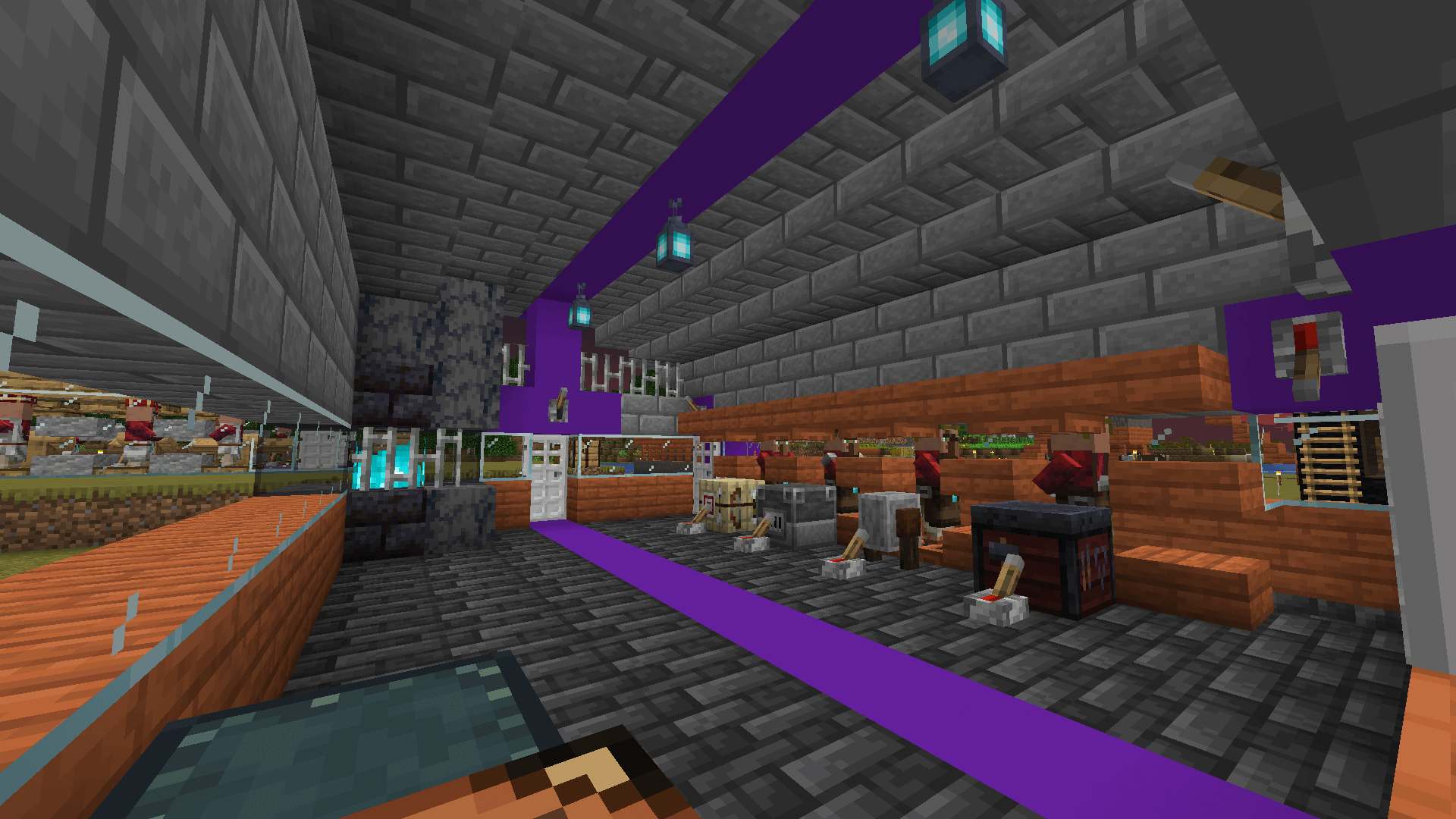 The interior of a blacksmith building, with four working villagers. There is a soul fire behind glass in the corner.