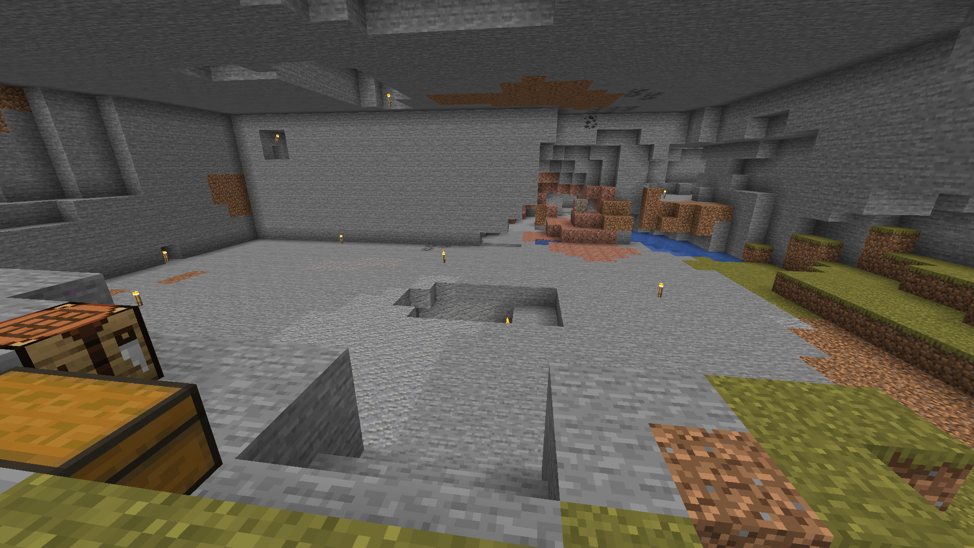 A large cuboid-shaped space mined out of a savanna hill.