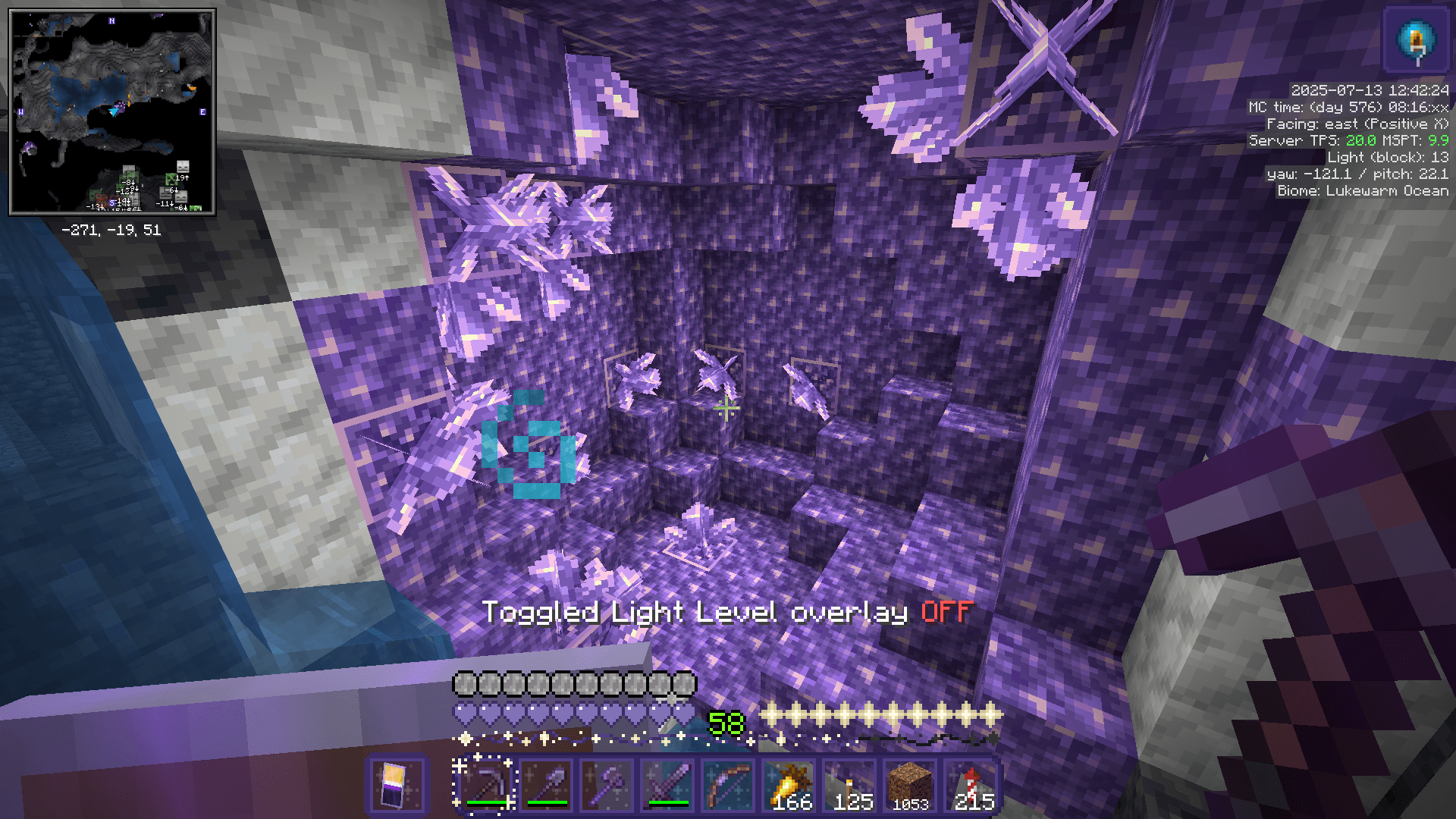 A fresh amethyst geode, with a stream of water running into it.