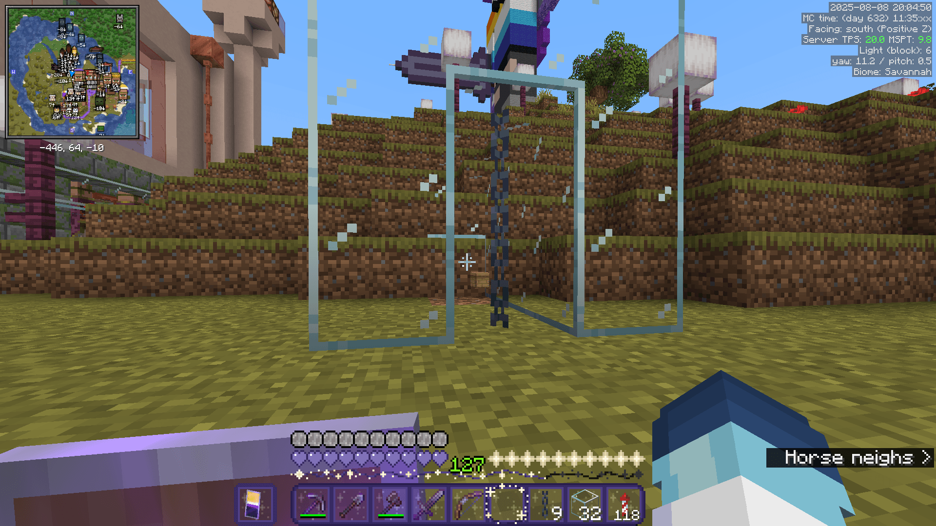 A beehive, as an item on the ground, inside a glass case designed to keep in any bees that might pop out of the hive.