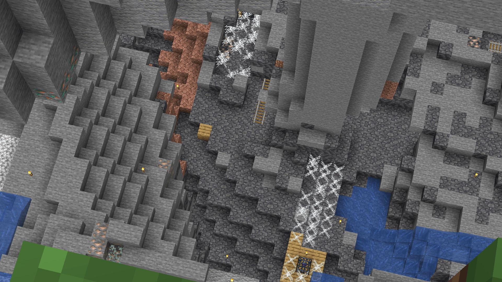 Looking down from the grass surface into a deepslate cave with two cave spider spawners.