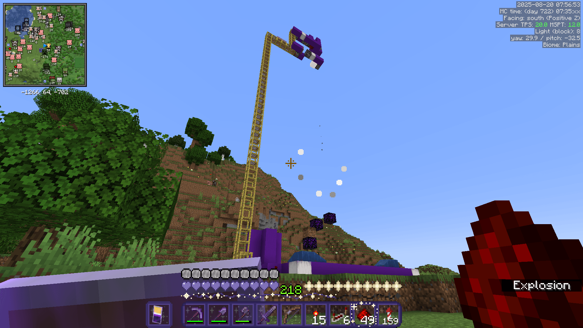 A tall scaffolding tower with a TNT-duping redstone circuit at the top. The setup is still intact after a TNT explosion.