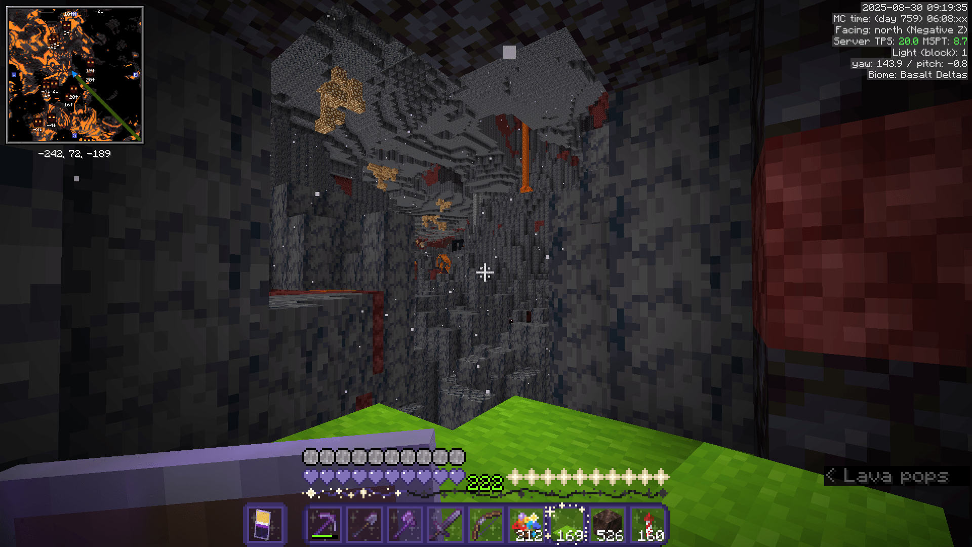 Looking out from a lime carpet tunnel over an open area of basalt delta. A broken nether portal is visible in the distance.