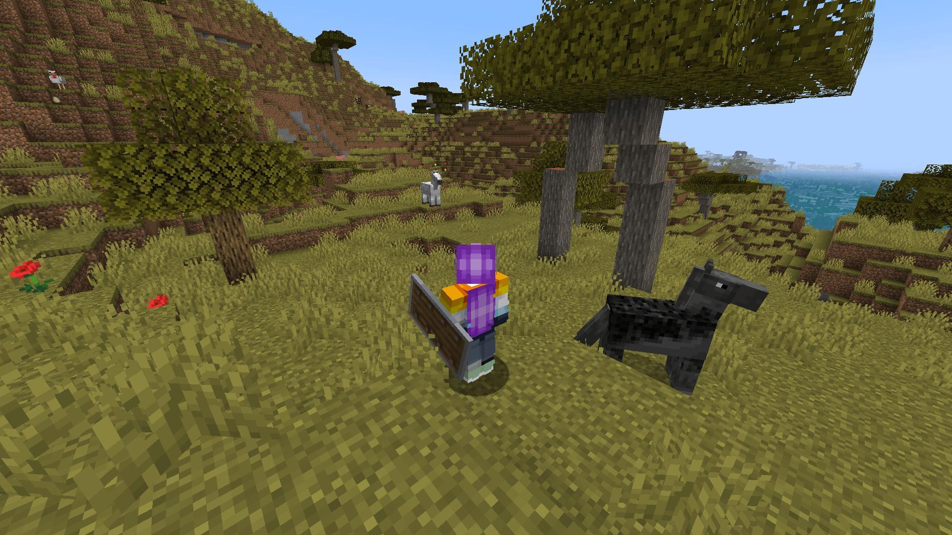 Fun fact, if you load up another world with the same seed, the same horses will spawn but their stats will be different! Two horses on a savannah hillside.